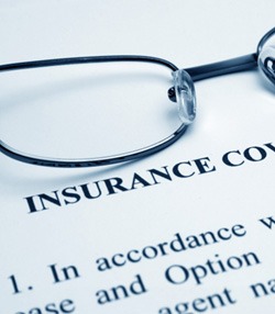Insurance coverage information sheet with glasses on top of it